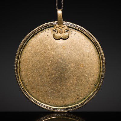 Lot 8 - A TIBETAN RITUAL GILT-BRONZE PENDANT MIRROR, MELONG, 16TH-17TH CENTURY