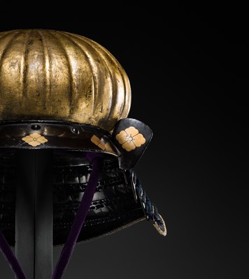 Lot 95 - A VERY RARE GILT-LACQUERED IRON ‘AKODA-NARI’ KAWARI KABUTO (ECCENTRICALLY SHAPED HELMET) WITH GOTO CLAN MON