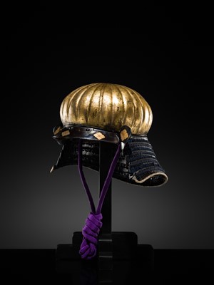 Lot 95 - A VERY RARE GILT-LACQUERED IRON ‘AKODA-NARI’ KAWARI KABUTO (ECCENTRICALLY SHAPED HELMET) WITH GOTO CLAN MON