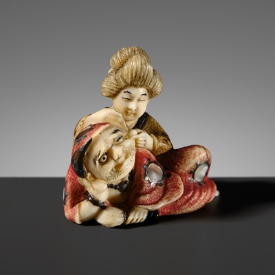 Lot 507 - KOGYOKU: A SMALL AND FINE ‘DARUMA AND COURTESAN’ TOKYO SCHOOL INLAID IVORY NETSUKE