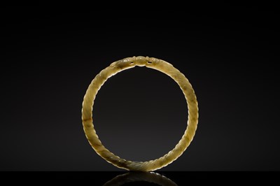A DELICATE CELADON AND BROWN ’DRAGON’ JADE ROPE-TWIST BANGLE, QING DYNASTY