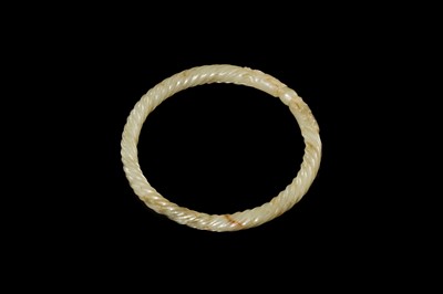 A DELICATE CELADON AND BROWN ’DRAGON’ JADE ROPE-TWIST BANGLE, QING DYNASTY