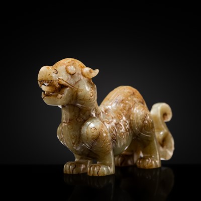 Lot 186 - AN ARCHAISTIC CELADON AND BROWN JADE FIGURE OF A MYTHICAL BEAST, QING DYNASTY