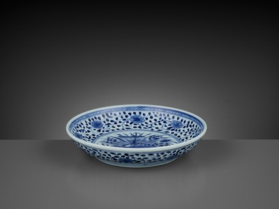 Lot 259 - A MING-STYLE BLUE AND WHITE ‘LOTUS BOUQUET’ DISH, 18TH CENTURY