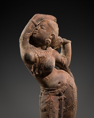Lot 332 - A RED SANDSTONE FIGURE OF A CELESTIAL WOMAN, RAJASTHAN, 11TH-12TH CENTURY