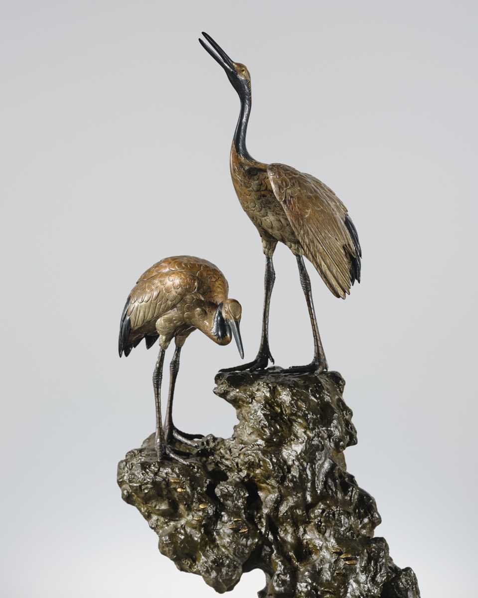 Lot 9 - MASAMITSU: AN IMPRESSIVE SILVER-PATINATED BRONZE OKIMONO OF TWO CRANES ON A ROCK