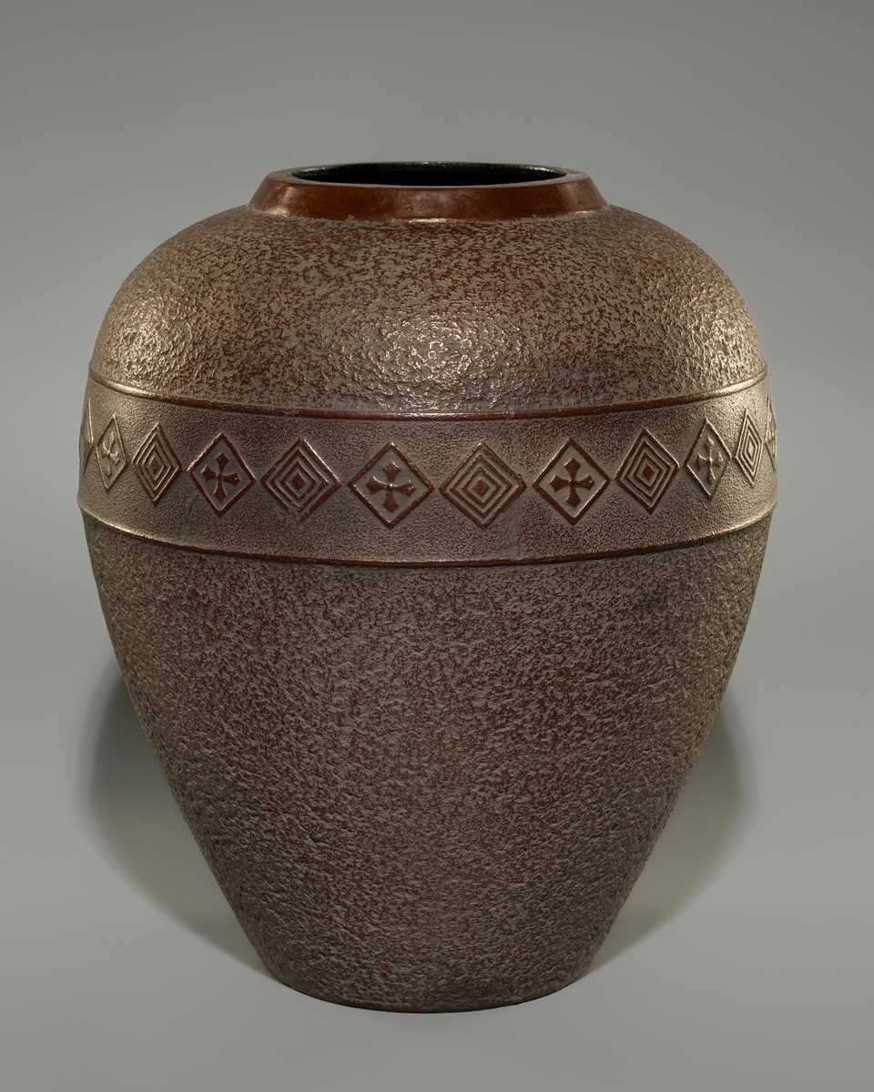 A LARGE IRON VASE WITH GEOMETRIC DECORATION