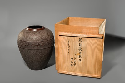 A LARGE IRON VASE WITH GEOMETRIC DECORATION