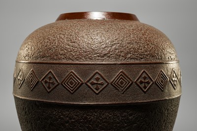 A LARGE IRON VASE WITH GEOMETRIC DECORATION