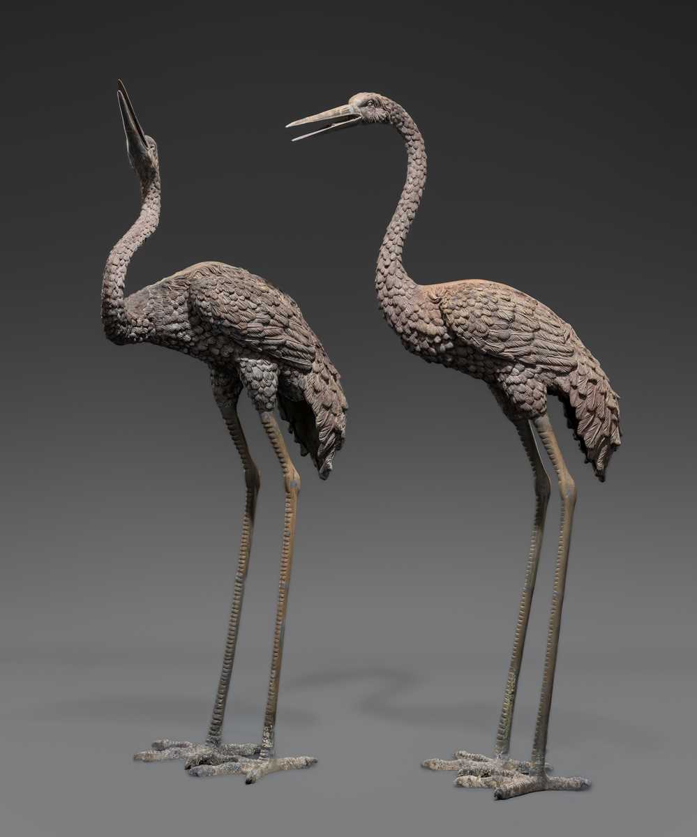 A PAIR OF LARGE BRONZE FIGURES OF CRANES