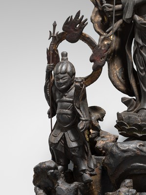 A LACQUERED WOOD FIGURE WITH A TRIAD OF KANNON BOSATSU AND ACOLYTES