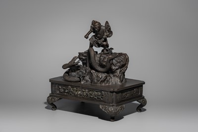 A BRONZE FIGURE OF A SNAKE SLAYING WARRIOR