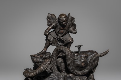 A BRONZE FIGURE OF A SNAKE SLAYING WARRIOR