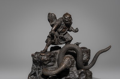 A BRONZE FIGURE OF A SNAKE SLAYING WARRIOR