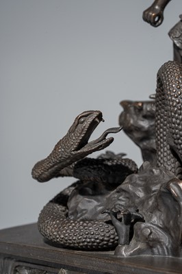 A BRONZE FIGURE OF A SNAKE SLAYING WARRIOR