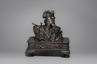 A BRONZE FIGURE OF A SNAKE SLAYING WARRIOR