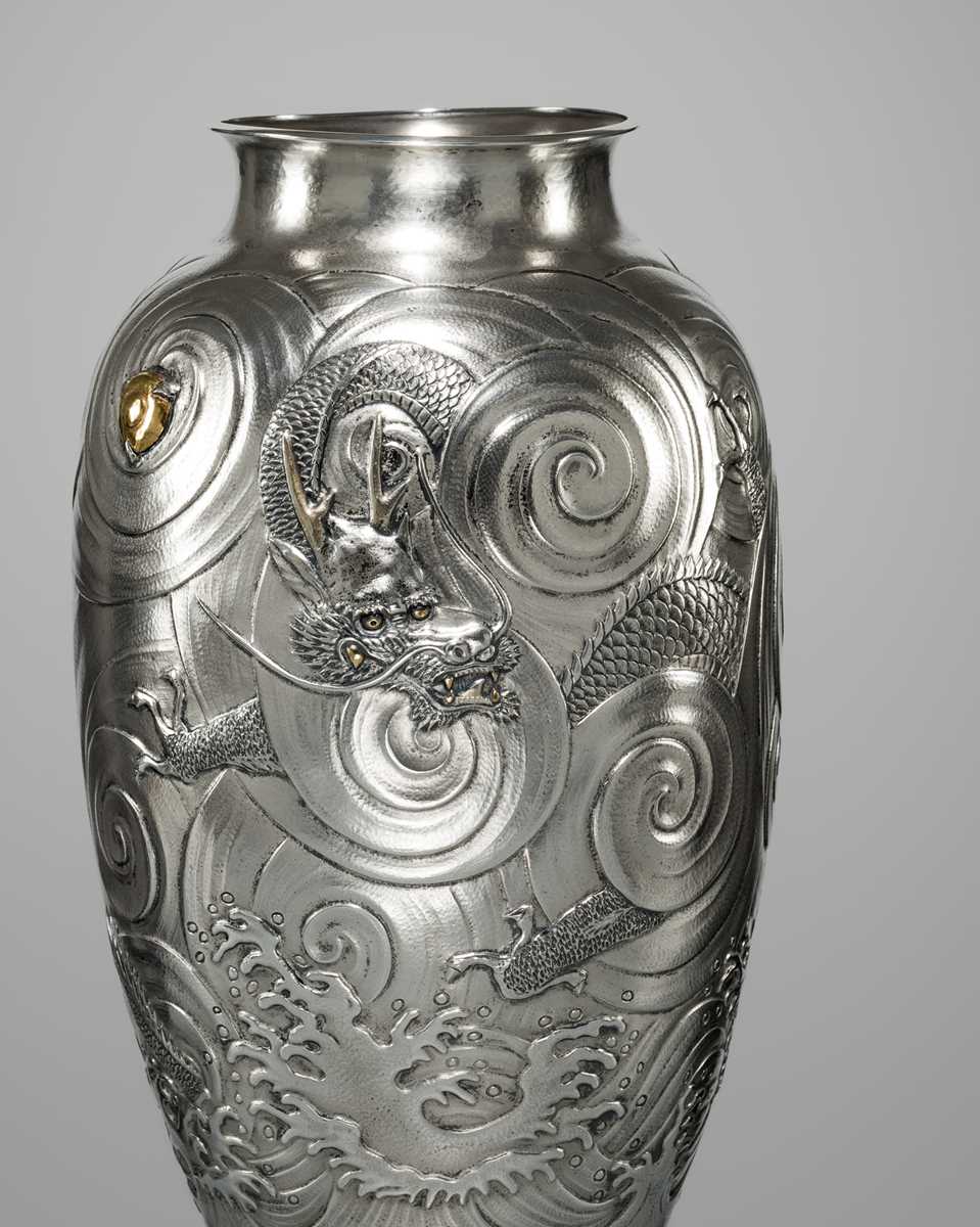 Lot 22 - KAWASHIMA TOSHU: A SUPERB AND LARGE GOLD-INLAID UCHIDASHI (REPOUSSÉ) SILVER ‘DRAGON’ VASE