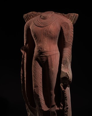 Lot 334 - AN ICONIC RED SANDSTONE TORSO OF THE BUDDHA, GUPTA PERIOD, MATHURA, 3RD-5TH CENTURY