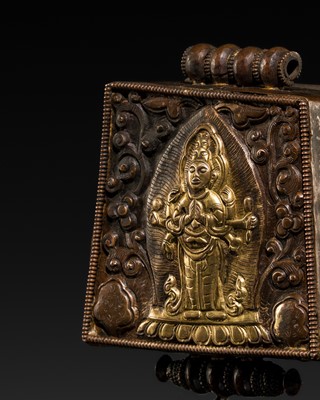 Lot 119 - A PARCEL-GILT COPPER REPOUSSÉ AMULET BOX DEPICTING EKADASHAMUKHA AVALOKITESHVARA, GAU, 19TH CENTURY