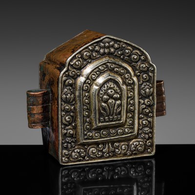 Lot 133 - AN EMBOSSED SILVER AND COPPER PORTABLE SHRINE DEPICTING THE CINTAMANI JEWEL, GAU, 18TH-19TH CENTURY