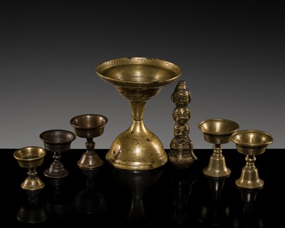 Lot 165 - A GROUP OF SIX BRASS BUTTER LAMPS AND A THREE-HEADED BRASS FIGURE, 19TH-20TH CENTURY AND EARLIER