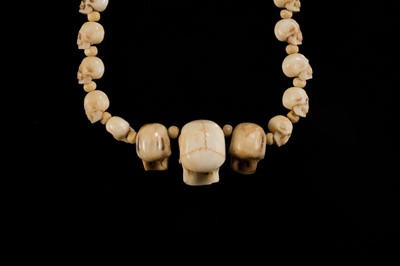 Lot 108 - AN EXCEPTIONALLY WELL CARVED BONE AND MARINE IVORY MALA WITH SKULL BEADS, SIN-‘PHEN, 18TH-19TH CENTURY