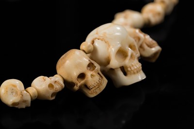 Lot 108 - AN EXCEPTIONALLY WELL CARVED BONE AND MARINE IVORY MALA WITH SKULL BEADS, SIN-‘PHEN, 18TH-19TH CENTURY