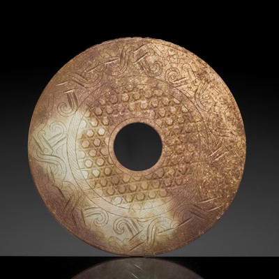 Lot 162 - A FINE RUSSET AND CELADON JADE ‘TAOTIE MASK’ DISK, BI, WESTERN HAN DYNASTY