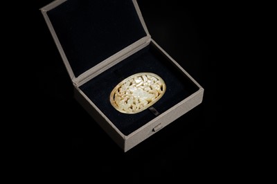 A WHITE AND RUSSET JADE PLAQUE WITH A HUMAN FIGURE AMONG FOLIAGE, LATE QING DYNASTY OR EARLIER