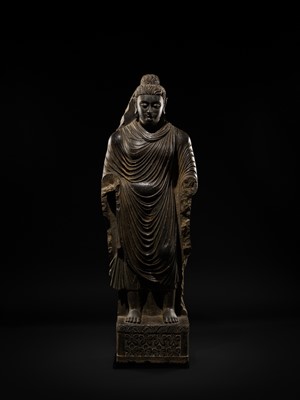 Lot 16 - A LARGE AND IMPORTANT POLISHED GRAY SCHIST FIGURE OF BUDDHA SHAKYAMUNI, ANCIENT REGION OF GANDHARA, SWAT VALLEY, 2ND-4TH CENTURY