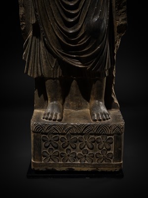 Lot 16 - A LARGE AND IMPORTANT POLISHED GRAY SCHIST FIGURE OF BUDDHA SHAKYAMUNI, ANCIENT REGION OF GANDHARA, SWAT VALLEY, 2ND-4TH CENTURY
