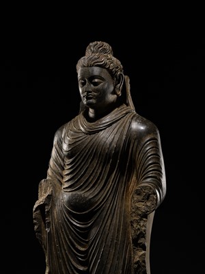 Lot 16 - A LARGE AND IMPORTANT POLISHED GRAY SCHIST FIGURE OF BUDDHA SHAKYAMUNI, ANCIENT REGION OF GANDHARA, SWAT VALLEY, 2ND-4TH CENTURY