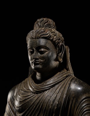 Lot 16 - A LARGE AND IMPORTANT POLISHED GRAY SCHIST FIGURE OF BUDDHA SHAKYAMUNI, ANCIENT REGION OF GANDHARA, SWAT VALLEY, 2ND-4TH CENTURY