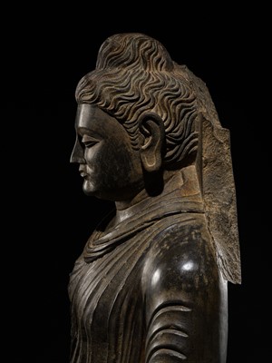 Lot 16 - A LARGE AND IMPORTANT POLISHED GRAY SCHIST FIGURE OF BUDDHA SHAKYAMUNI, ANCIENT REGION OF GANDHARA, SWAT VALLEY, 2ND-4TH CENTURY