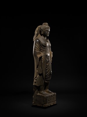 Lot 16 - A LARGE AND IMPORTANT POLISHED GRAY SCHIST FIGURE OF BUDDHA SHAKYAMUNI, ANCIENT REGION OF GANDHARA, SWAT VALLEY, 2ND-4TH CENTURY