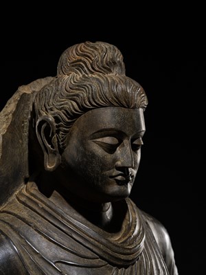Lot 16 - A LARGE AND IMPORTANT POLISHED GRAY SCHIST FIGURE OF BUDDHA SHAKYAMUNI, ANCIENT REGION OF GANDHARA, SWAT VALLEY, 2ND-4TH CENTURY
