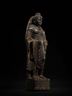 Lot 16 - A LARGE AND IMPORTANT POLISHED GRAY SCHIST FIGURE OF BUDDHA SHAKYAMUNI, ANCIENT REGION OF GANDHARA, SWAT VALLEY, 2ND-4TH CENTURY