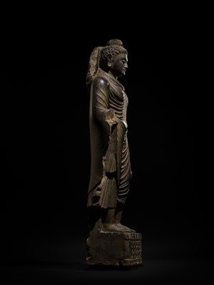 Lot 16 - A LARGE AND IMPORTANT POLISHED GRAY SCHIST FIGURE OF BUDDHA SHAKYAMUNI, ANCIENT REGION OF GANDHARA, SWAT VALLEY, 2ND-4TH CENTURY