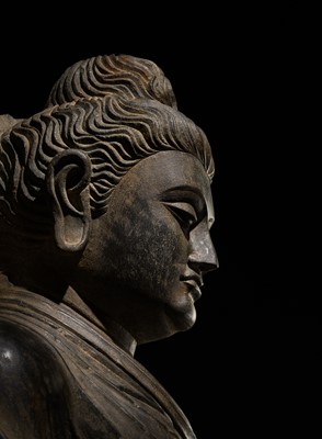 Lot 16 - A LARGE AND IMPORTANT POLISHED GRAY SCHIST FIGURE OF BUDDHA SHAKYAMUNI, ANCIENT REGION OF GANDHARA, SWAT VALLEY, 2ND-4TH CENTURY