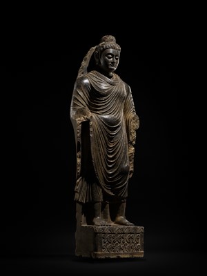 Lot 16 - A LARGE AND IMPORTANT POLISHED GRAY SCHIST FIGURE OF BUDDHA SHAKYAMUNI, ANCIENT REGION OF GANDHARA, SWAT VALLEY, 2ND-4TH CENTURY