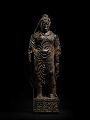Lot 16 - A LARGE AND IMPORTANT POLISHED GRAY SCHIST FIGURE OF BUDDHA SHAKYAMUNI, ANCIENT REGION OF GANDHARA, SWAT VALLEY, 2ND-4TH CENTURY