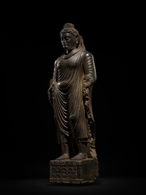 Lot 16 - A LARGE AND IMPORTANT POLISHED GRAY SCHIST FIGURE OF BUDDHA SHAKYAMUNI, ANCIENT REGION OF GANDHARA, SWAT VALLEY, 2ND-4TH CENTURY