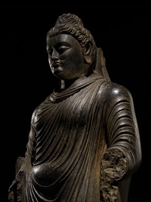 Lot 16 - A LARGE AND IMPORTANT POLISHED GRAY SCHIST FIGURE OF BUDDHA SHAKYAMUNI, ANCIENT REGION OF GANDHARA, SWAT VALLEY, 2ND-4TH CENTURY