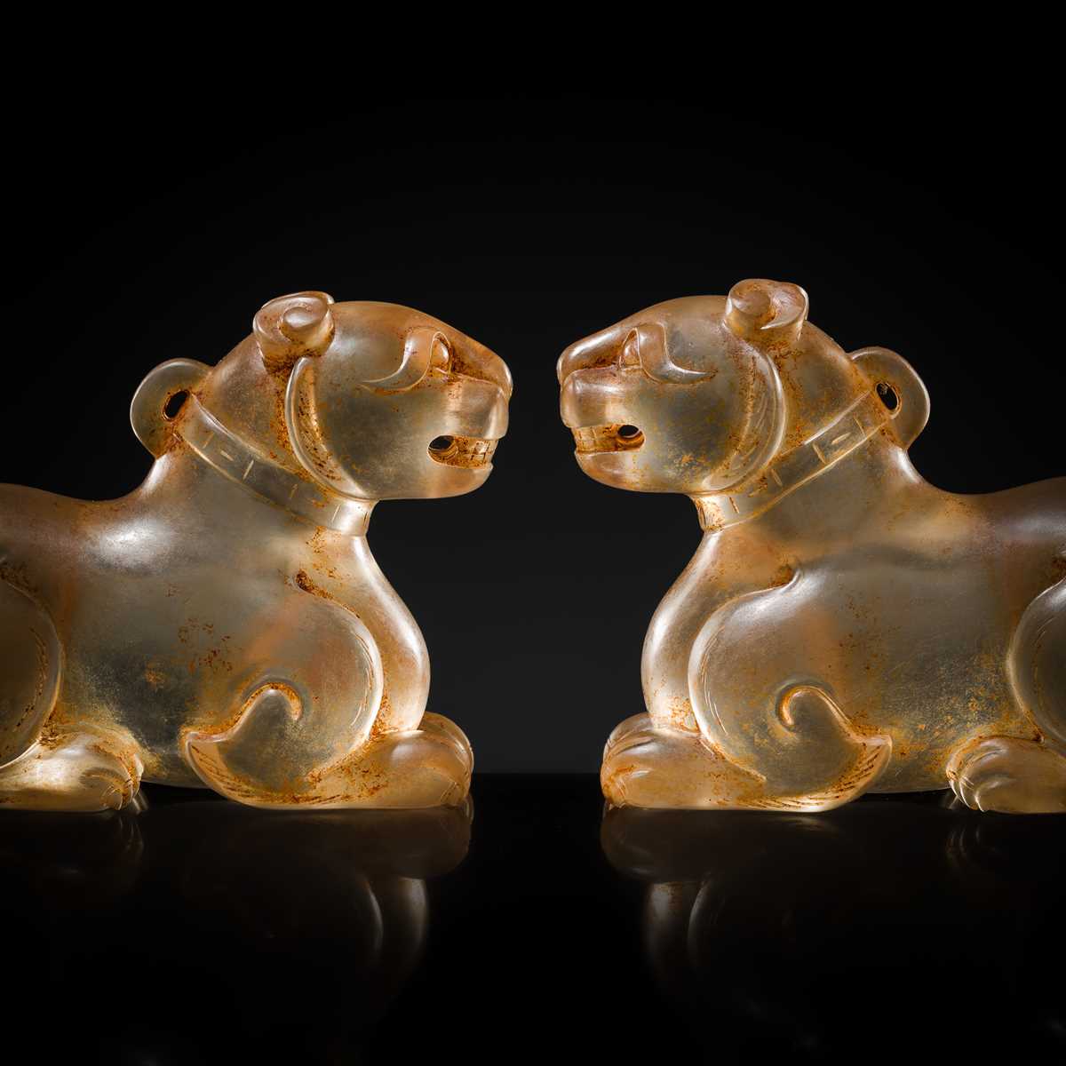 Lot 31 - AN EXCEPTIONALLY WELL CARVED PAIR OF ROCK CRYSTAL FELINE FIGURES, HAN DYNASTY