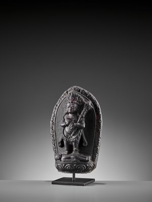 Lot 450 - A SINO-TIBETAN BLACK STONE FIGURE OF PANJARANATA MAHAKALA, 17TH CENTURY