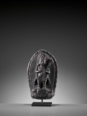 Lot 450 - A SINO-TIBETAN BLACK STONE FIGURE OF PANJARANATA MAHAKALA, 17TH CENTURY