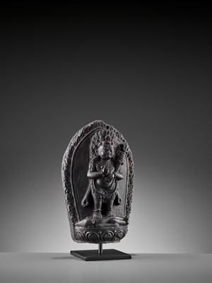 Lot 450 - A SINO-TIBETAN BLACK STONE FIGURE OF PANJARANATA MAHAKALA, 17TH CENTURY
