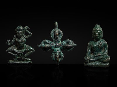 Lot 417 - A GROUP LOT WITH THREE MINIATURE BRONZE FIGURES DEPICTING BUDDHA, A DANCING APSARA, AND A RITUAL VAJRA, KHMER EMPIRE, ANGKOR PERIOD, 12TH-13TH CENTURY