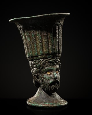 Lot 304 - A BRONZE STEM CUP WITH A MALE HEAD, PROBABLY ROMAN CULTURE, CIRCA 2ND-3RD CENTURY