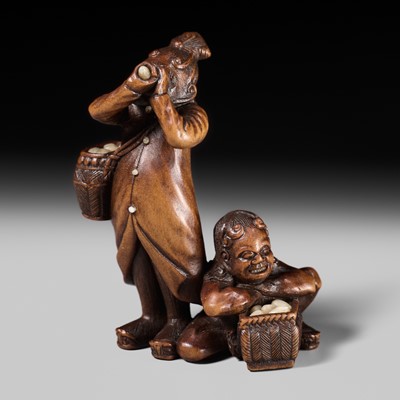 NAOYUKI: A VERY FINE INLAID WOOD NETSUKE OF TWO EGG TESTERS